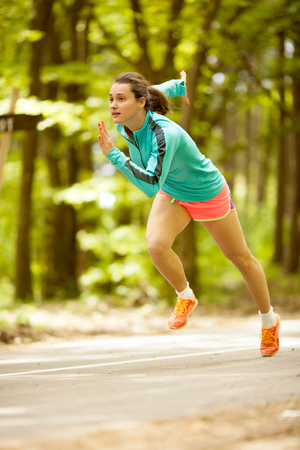 Runner athlete running on forest trail. woman fitness joggingの写真素材