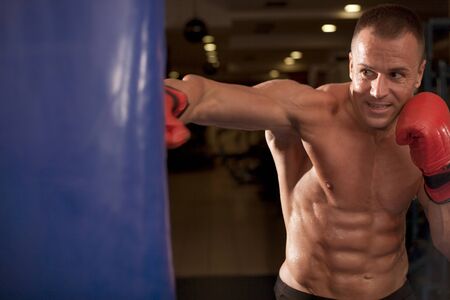 Portrait of boxer posing in studio in glovesの写真素材