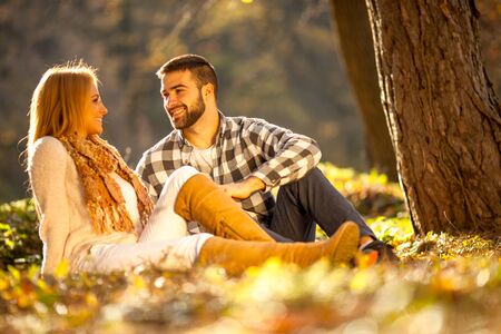 Beautiful couple in love in colorful parkの写真素材