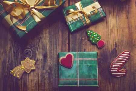Christmas background with decorations and handmade gift boxes on old wooden board, vintage filter effectの写真素材