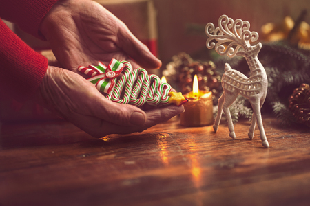 Hands of woman decorating Christmas gifts and decorationsの写真素材