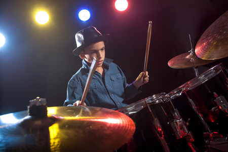 young child musician playing the drumsの写真素材