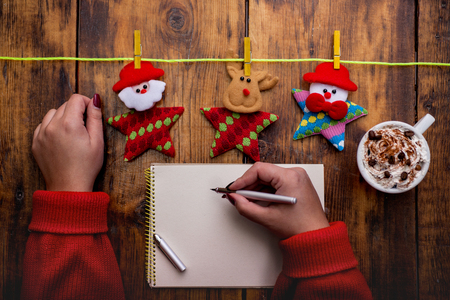 Santa's hands, make a wish list for Christmas nightの写真素材