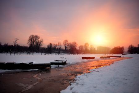 beautiful sunset in frosty evening at the riverの写真素材