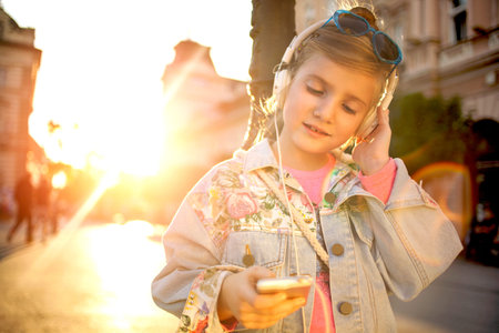 happy girl child listen to the music from her smartphoneの写真素材