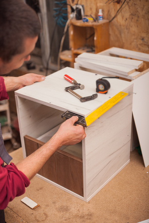 carpenter  with yardstick in workshopの写真素材