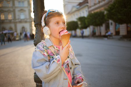 happy girl child listen to the music from her smartphoneの写真素材