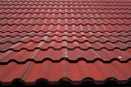 Faded corregated red tile roof in the sun 