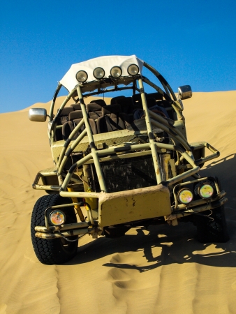 Desert buggy on the steep sand duneの写真素材
