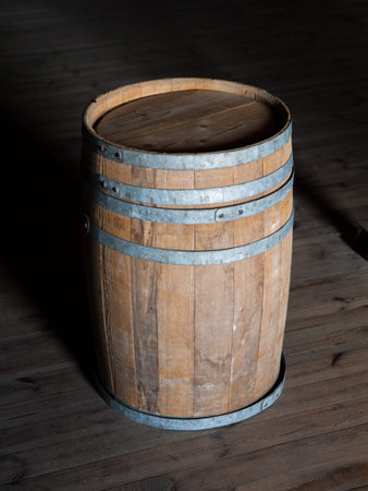 Old brown wooden barrel on a wooden floor