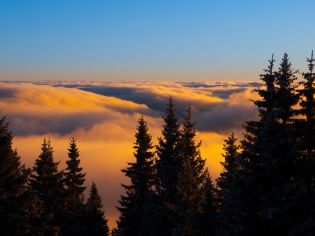 Winter inversion clouds in the mounains at sunset timeの写真素材