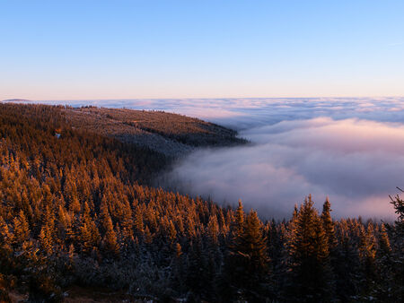 Winter inversion clouds in the mounains at sunset timeの写真素材