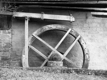Old mill water wheel without water, no motion, black and white image