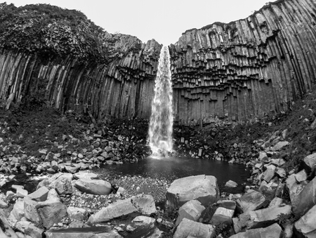Svartifoss waterfall with basalt columns in Skaftafell National Park, Iceland, black and white imageの写真素材