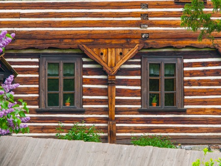 Two windows of old timbered house, typical czech rural architecureの写真素材