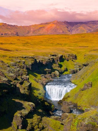 Green landscape with small waterfall on Skoga river near Skogar, Icelandの写真素材