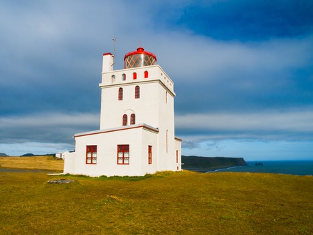 White lighthouse on the cape Dyrholaey, Southern Icelandの写真素材