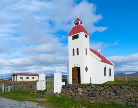 Typical white small church in icelandic villageの写真素材