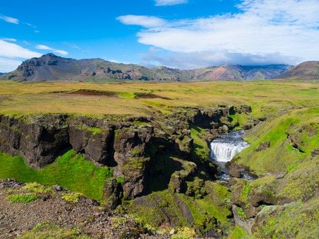 Green landscape with small waterfall on Skoga river near Skogar, Icelandの写真素材