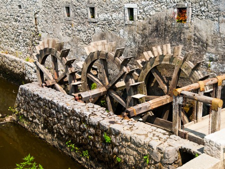 Detailed view of three water wheels of an old millの写真素材