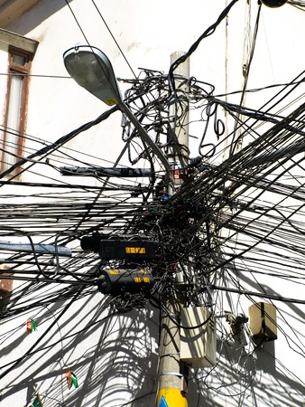 Many wires on an lamp post. Typical for less developed countries.の写真素材
