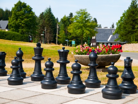 Black figures of giant outdoor chess in the parkの写真素材