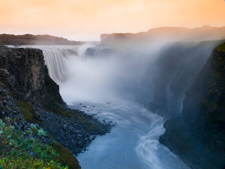 Godafoss waterfall in misty veil illuminated by sunset, Icelandの写真素材