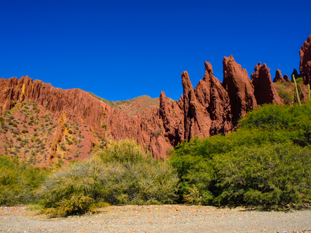 Red rock formations in the dry valley - quebrada - of western-like landscape near small town Tupiza in southern Boliviaの写真素材