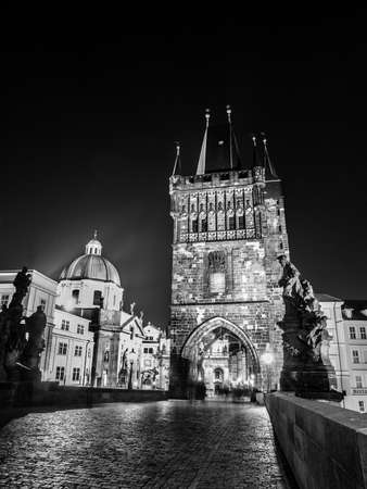 Night View of Charles Bridge in Prague with Old Town Bridge Tower, Czech Republic. Black and white image.の写真素材