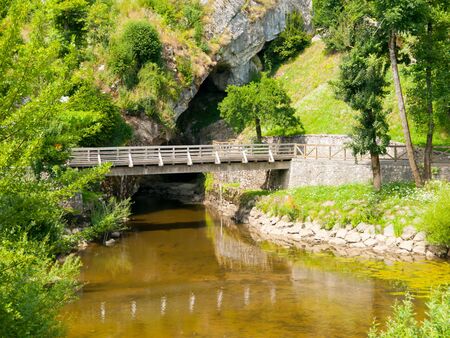 Pivka River swallow hole on with pedestrian bridge. Place where Pivka River enters Postojna Cave, Slovenia.の写真素材