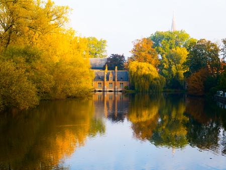 Autumn morning in Bruges at Lake of Love, or Minnewater, Belgiumの写真素材