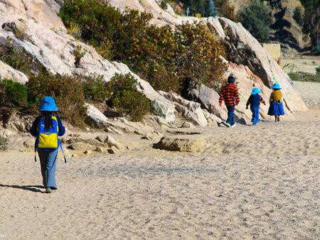 Three bolivian girls on the way to school in the morning, Isla del Sol, Titicaca Lake, Boliviaの写真素材