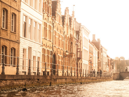 Medieval houses along canals of Bruges in autumn time, Belgiumの写真素材