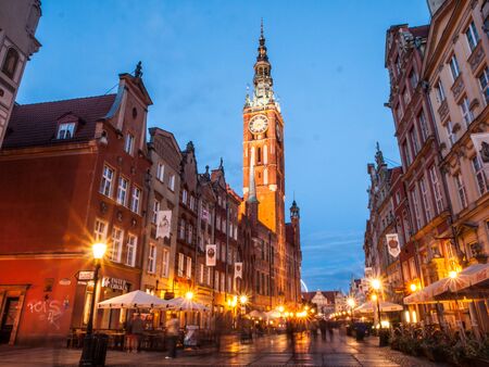 GDANSK, POLAND - CIRCA 2014: Long Lane, or Ulica Dluga, with Town Hall tower in Old town of Gdansk, Poland. Illuminated buildings and street rush by night.のeditorial素材