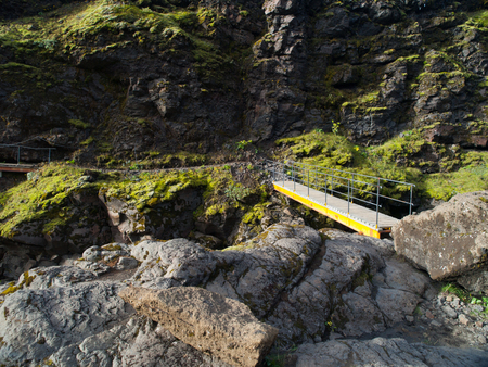Small wooden bridge over the glacial river canyon on the Laugavegur hiking trail, Icelandの写真素材