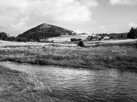 Conical mountain Bukovec above Jizerka village and Jizerka creek, Jizera Mountains, Czech Republic . Black and white image.の写真素材