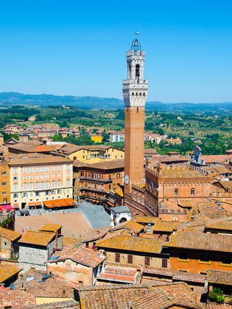 The Torre del Mangia, tower located in the ancient medieval historical city centre at Piazza del Campoin in Siena, Tuscany region, Italyの写真素材