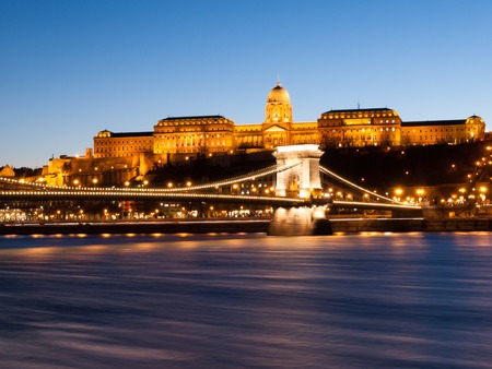 Illuminated Buda Castle and Chain Bridge over Danube River in Budapest by night, Hungary, Europe. UNESCO World Heritage Site. Long exposure shot with blurred water stream.の写真素材