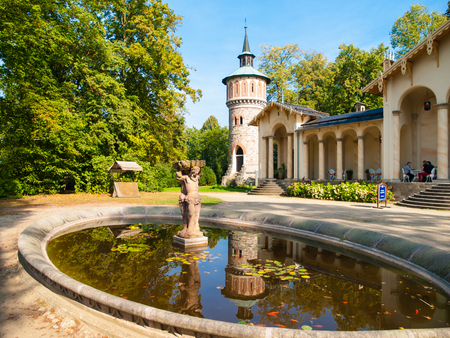 Garden pond with small statue at Orangerie of Sychrov Castle. Park water tower on the background. Bohemian Paradise, Northern Bohemia, Czech Republicの写真素材