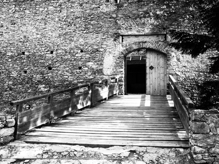 Entrance wooden bridge and gate of medieval stronghold Kasperk Castle near Kasperske Hory in Southern Bohemia, Sumava Mountains, Czech Republic, Europe.の写真素材