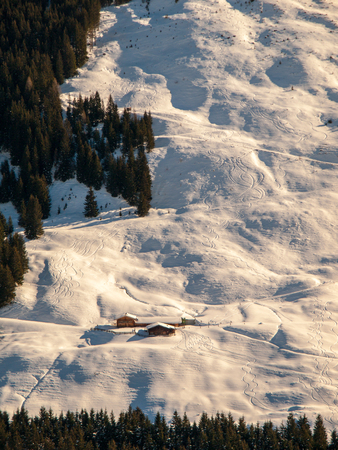 Evening view of alpine hut in the steep slope. Winter backountry ski touring area, Austrian Alps, Europe.の写真素材