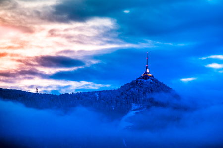Illuminated Jested transmitter tower and hotel. Blue cloudy evening in Liberec, Czech Republic.の写真素材