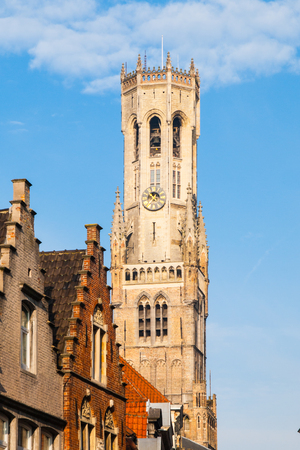 The Belfry Tower, aka Belfort, of Bruges, medieval bell tower in the historical centre of Bruges, Belgium. Close-up view of the top.の写真素材