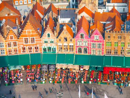 BRUGES, BELGIUM - OCTOBER 18, 2015: Market Square in Bruges with colorful houses and coffee gardens, Belgium on October 18, 2016.のeditorial素材