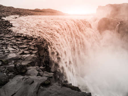 Detifoss waterfall illuminated by sunset, northern Iceland.の写真素材