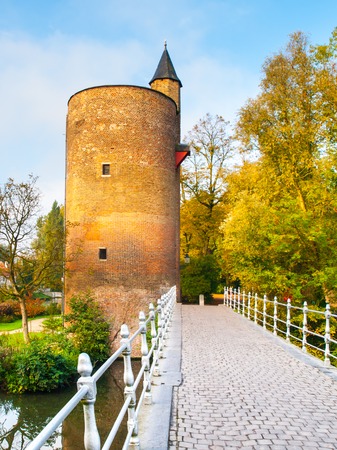 Old stone spillway tower at Minnewater lake, aka Lake of Love, in Bruges, Belgium.の写真素材