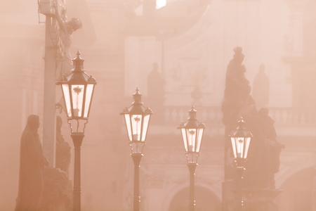 Street lamps on Charles bridge illuminated by sun in the morning, Old Town, Prague, Czech Republic.の写真素材