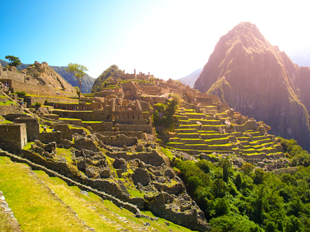 Ancient Inca City of Machu Picchu illuminated by sun. Ruins of Incan Lost city in Peruvian jungle.  Peru, South America.の写真素材
