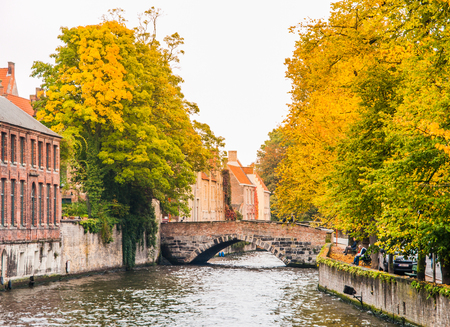 Town water canals with tourist boats in the historical center of Bruges, aka Brugge, Belgium, Europe.の写真素材