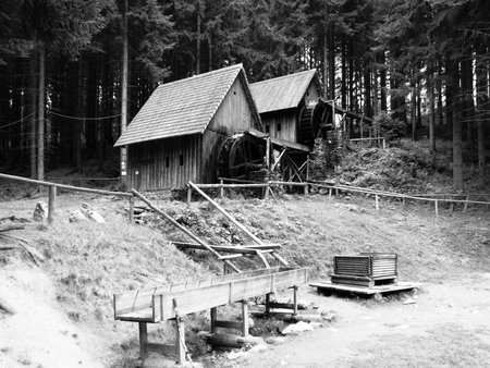 Gold ore mills. Medieval wooden water mills in Zlate Hory, Czech Republic. Black and white image.